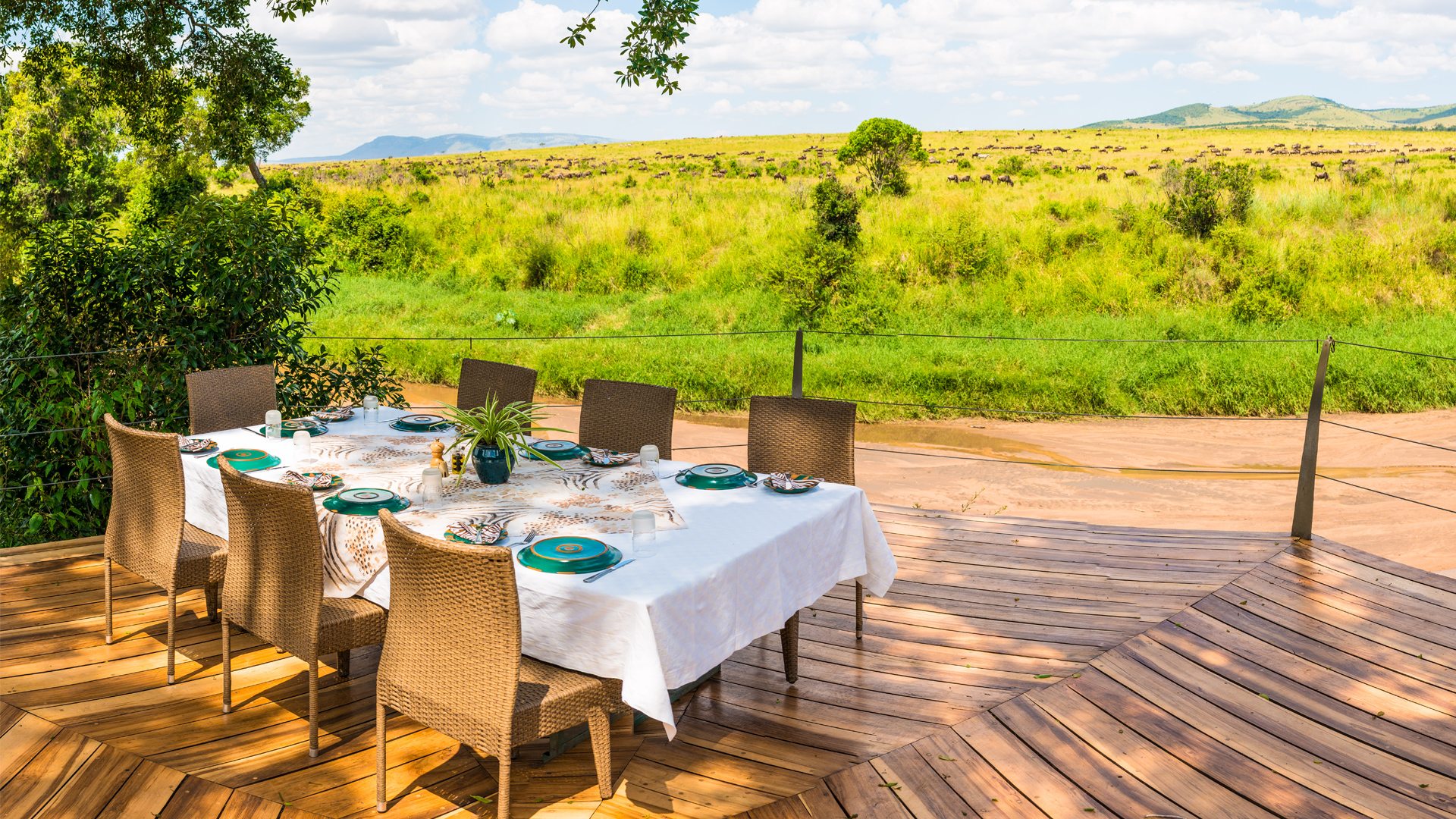 Elegant safari lodge dining deck overlooking the plains